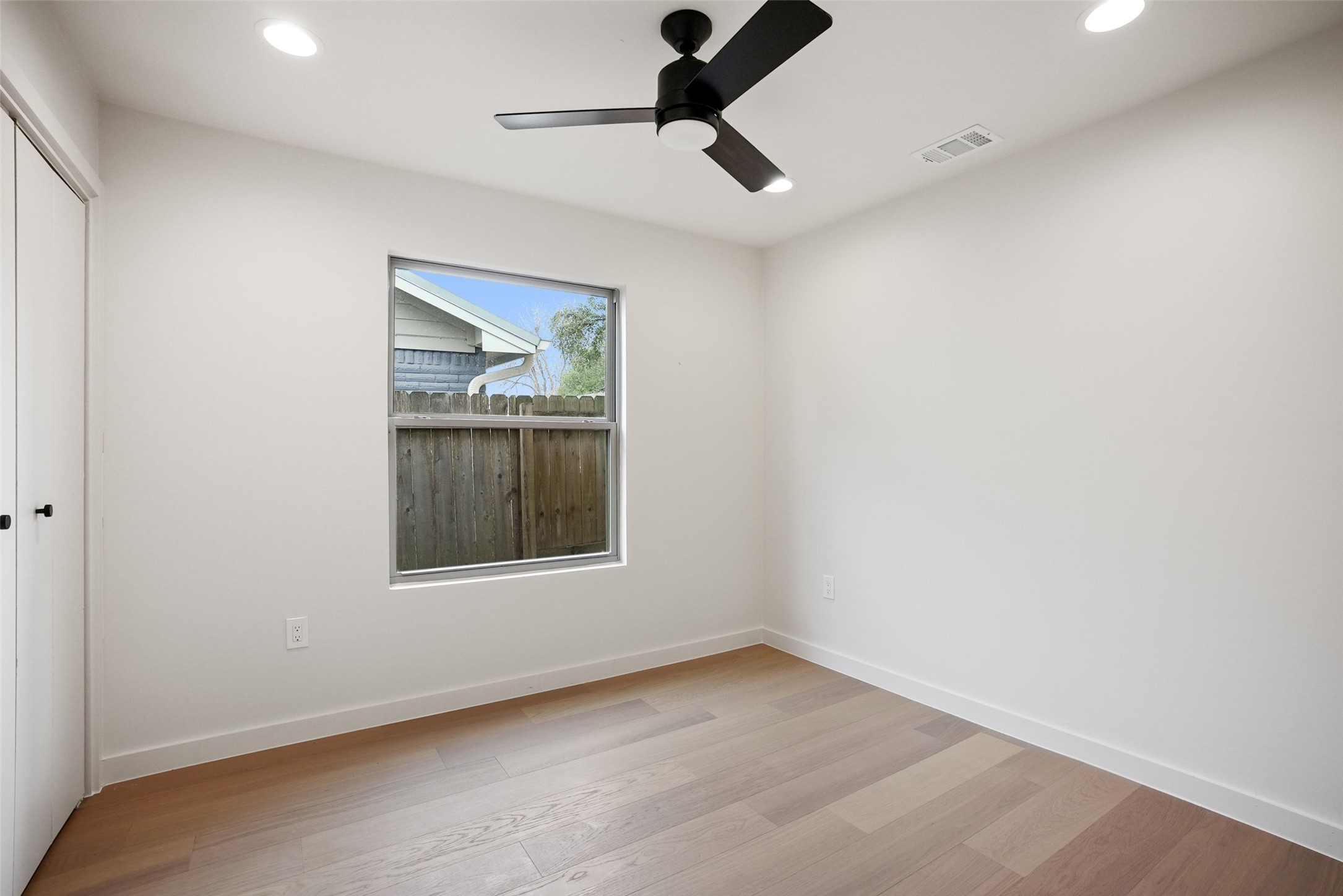 6307 Clubway Lane Austin, TX 78745 - Photo 26 of 34 an empty room with a window and a ceiling fan