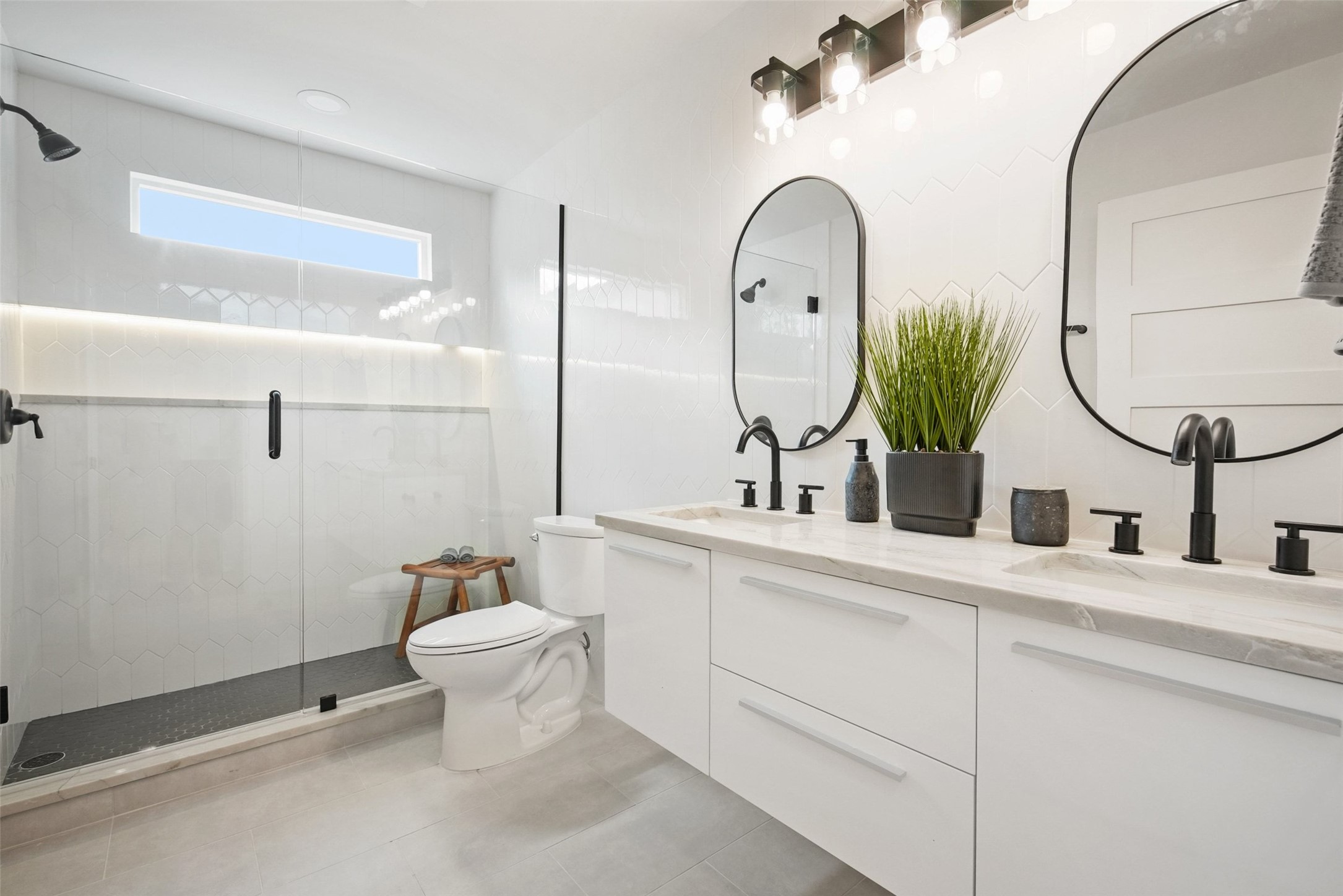 6307 Clubway Lane Austin, TX 78745 - Photo 28 of 34 a bathroom with a toilet sink and mirror