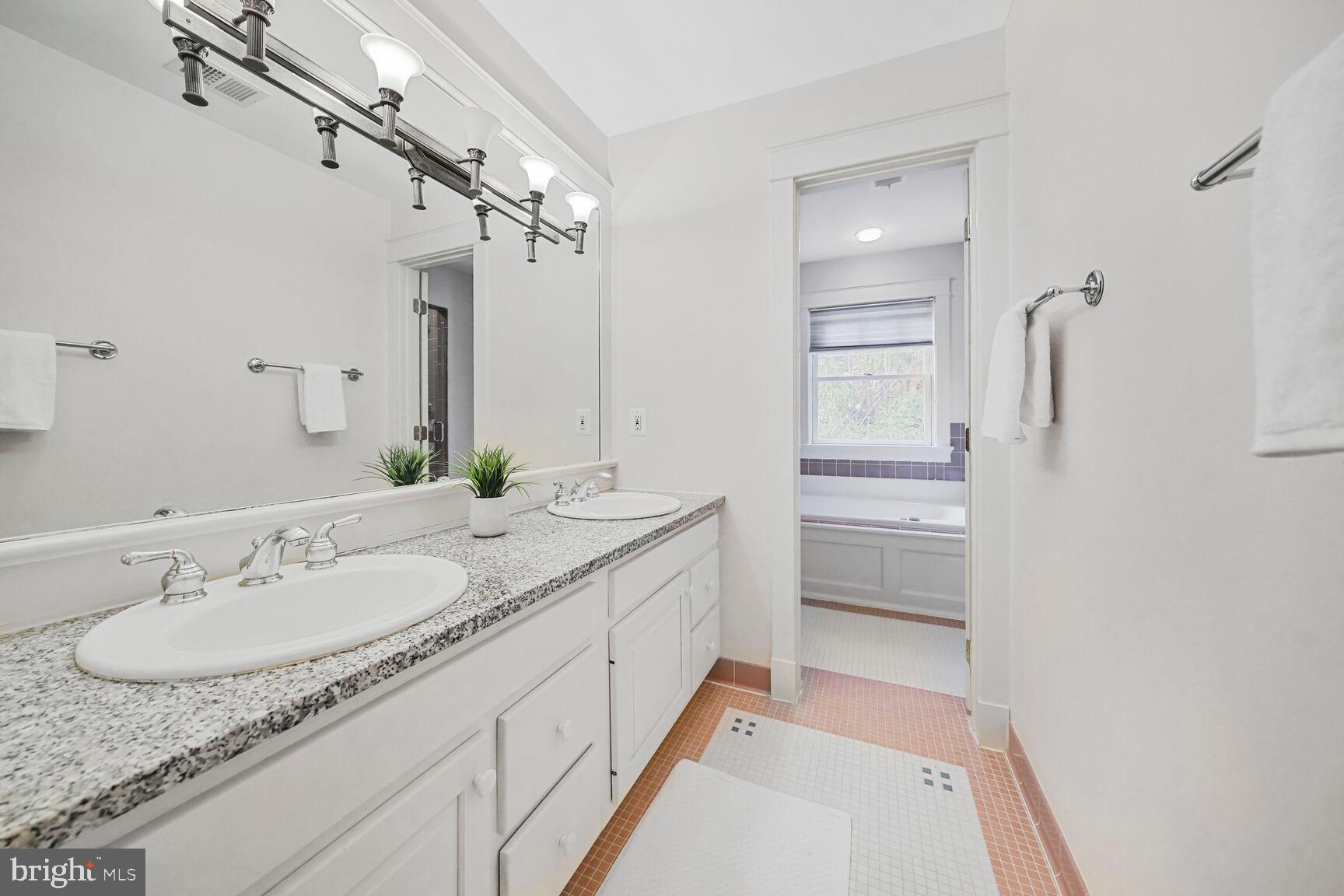 2012 Rockingham Street McLean, VA 22101 - Photo 22 of 45 a bathroom with a granite countertop sink and a mirror