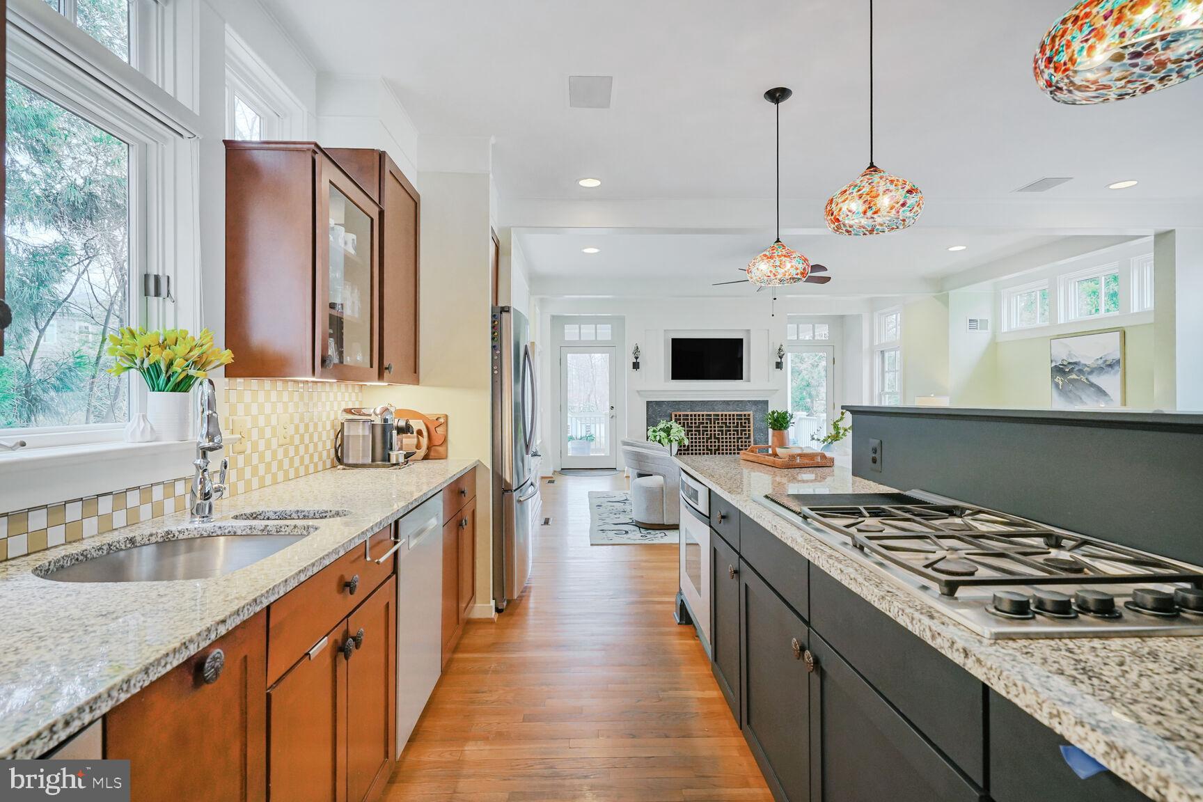 2012 Rockingham Street McLean, VA 22101 - Photo 10 of 45 a kitchen with stainless steel appliances granite countertop a stove a sink dishwasher and a refrigerator with wooden floor