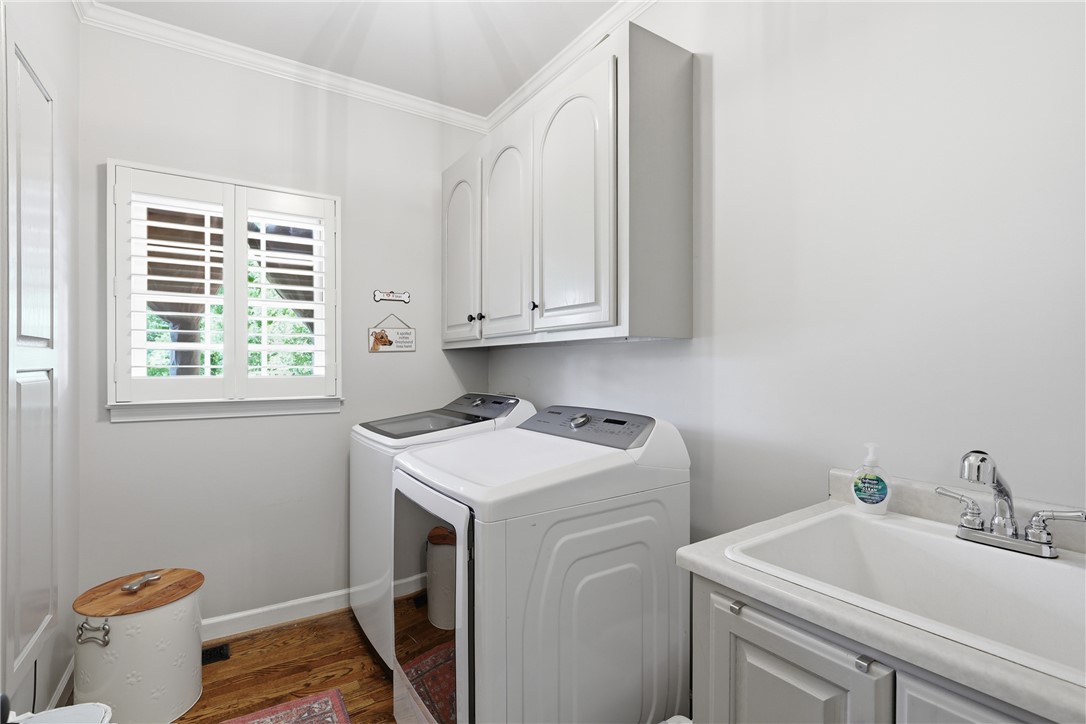 103 5 Knoll Court Anderson, SC 29621 - Photo 24 of 33 Functional laundry room offers built-in cabinetry, a utility sink, and abundant natural light.