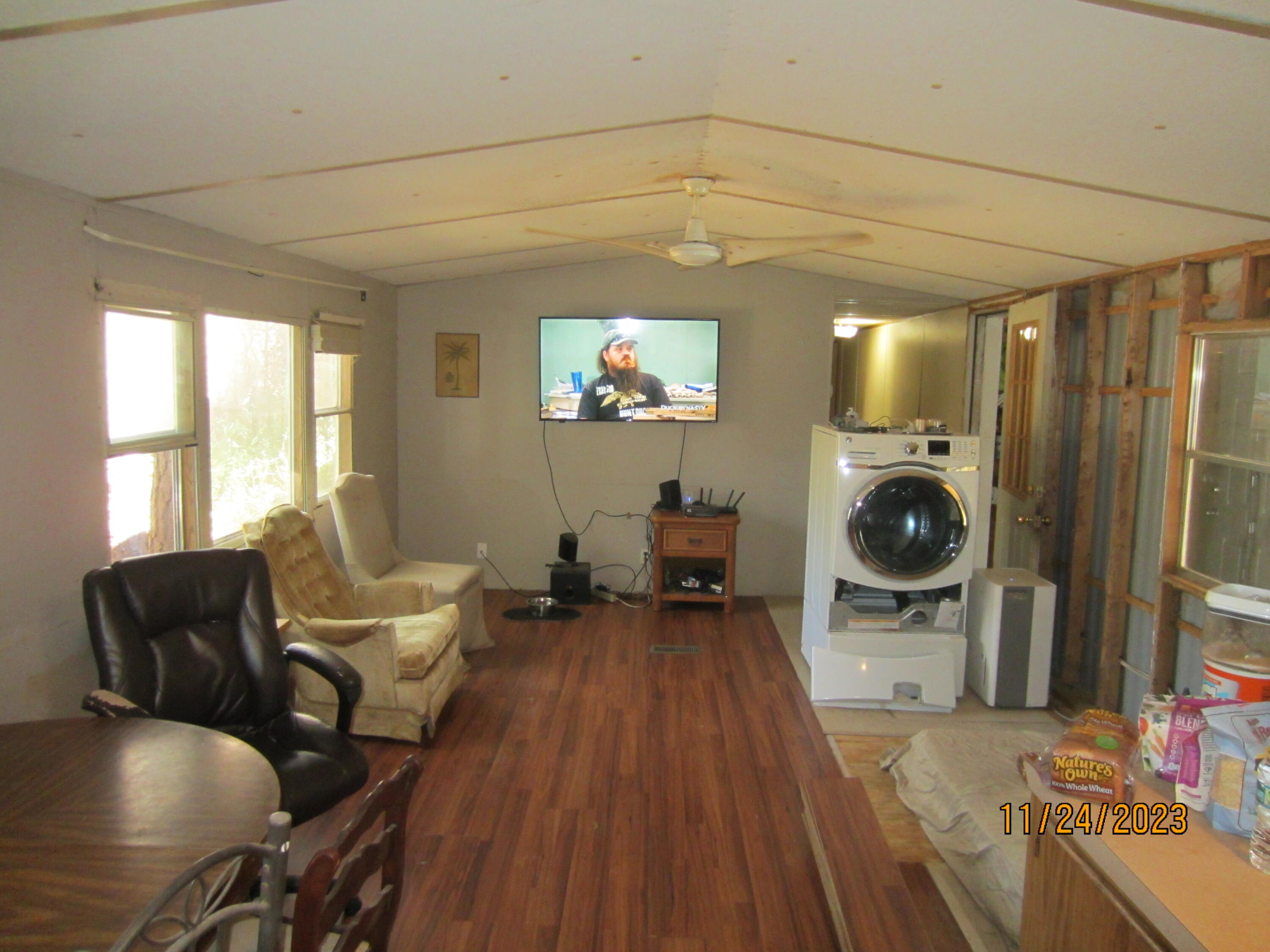 133 4th Street Santa Rosa Beach, FL 32459 - Photo 11 of 13 a living room with furniture a flat screen tv and a fireplace