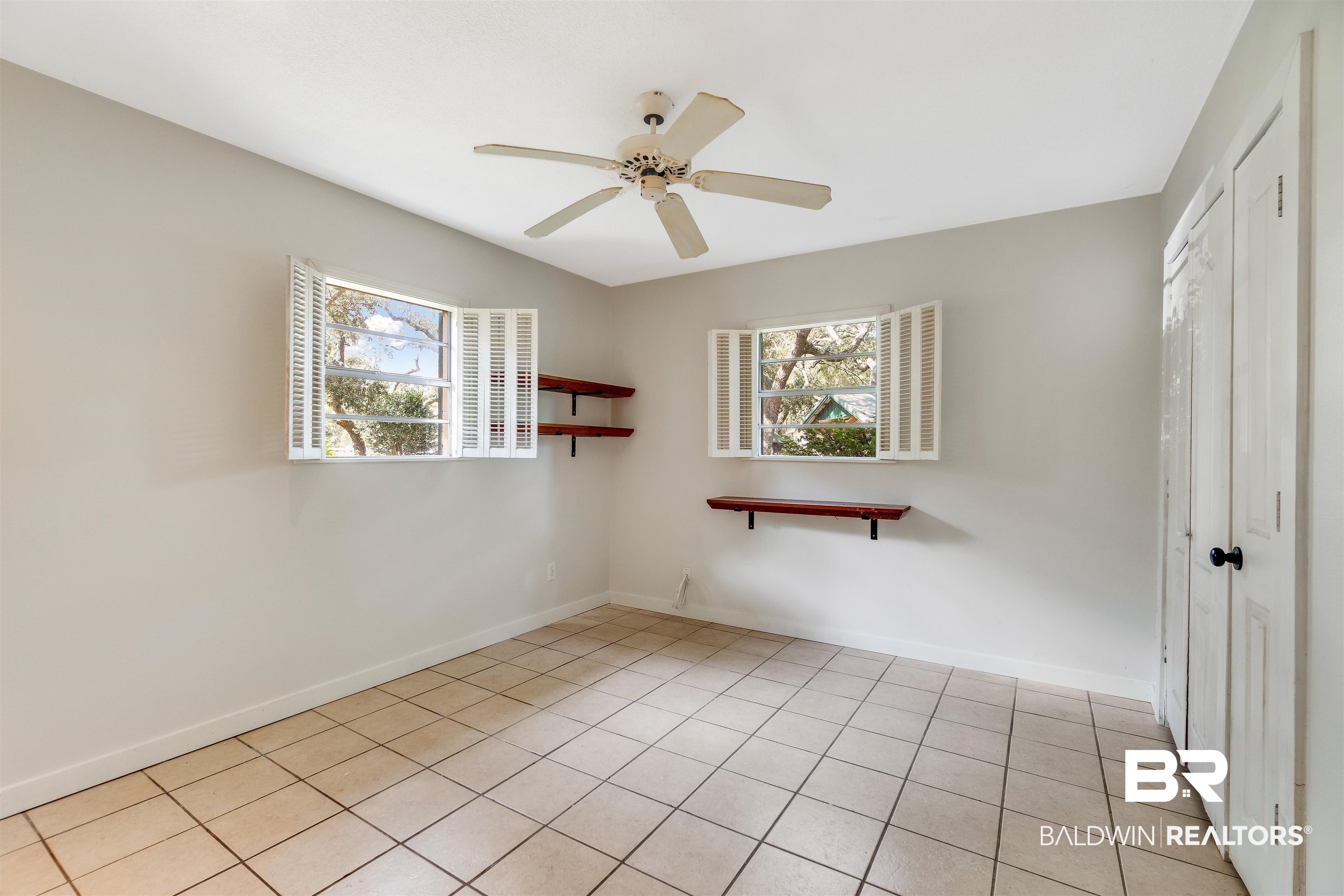 34341 Lost River Road Seminole, AL 36574 - Photo 14 of 36 Spare room featuring healthy amount of natural light, light tile patterned floors, and ceiling fan