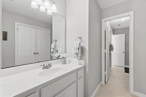 a bathroom with a toilet a sink and a large mirror