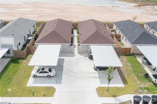 an aerial view of a house with swimming pool and patio