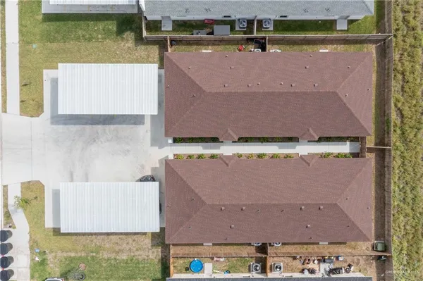 an aerial view of residential houses with outdoor space