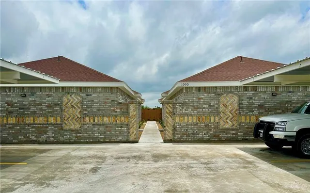a couple of cars parked in front of a building