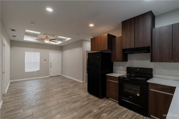 a kitchen with a refrigerator and a stove top oven