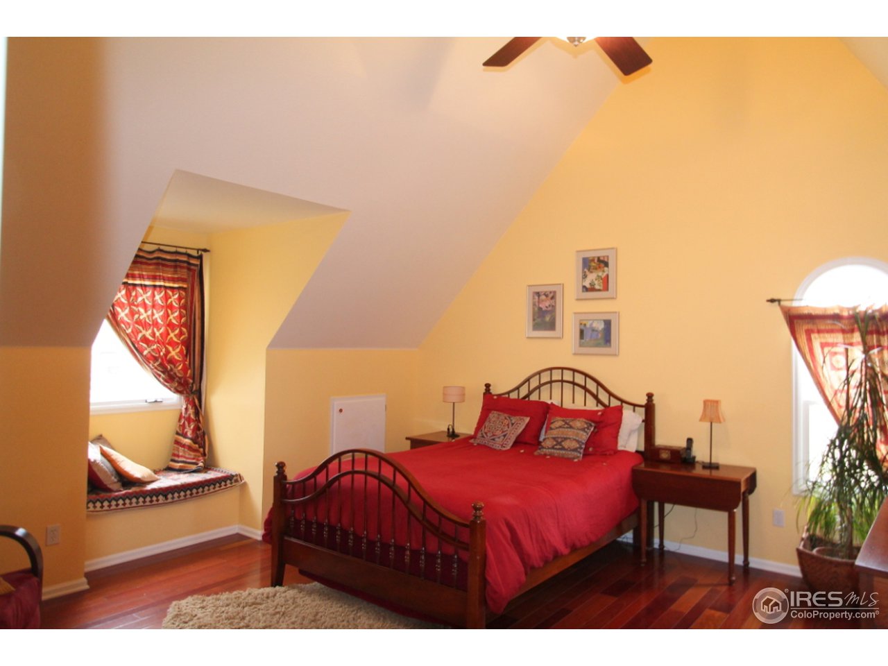411 High Court Fort Collins, CO 80521 - Photo 11 of 25 a bedroom with a bed a mirror and lamp