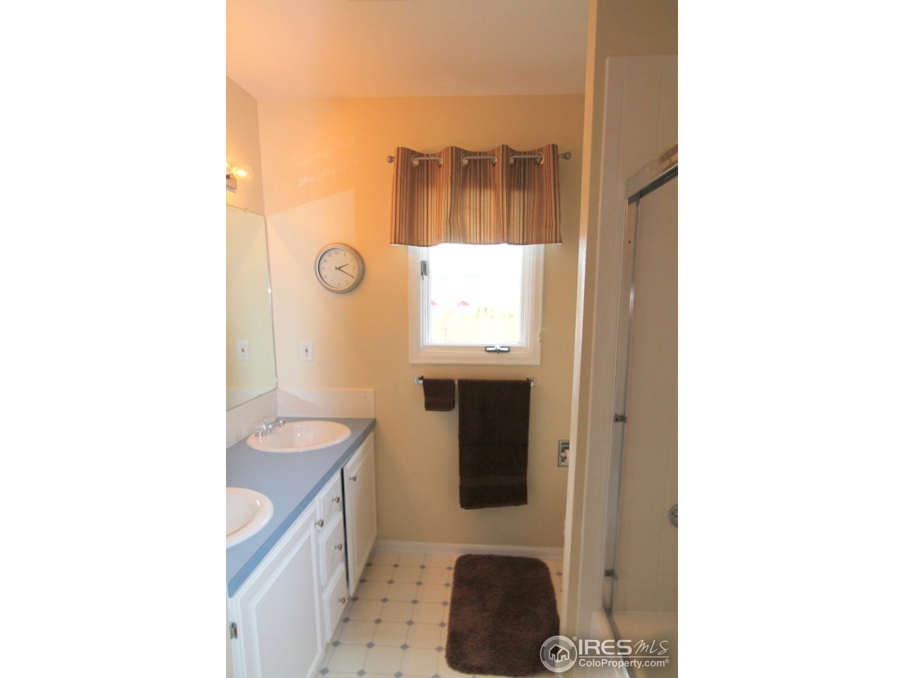 411 High Court Fort Collins, CO 80521 - Photo 17 of 25 a bathroom with a sink and a mirror