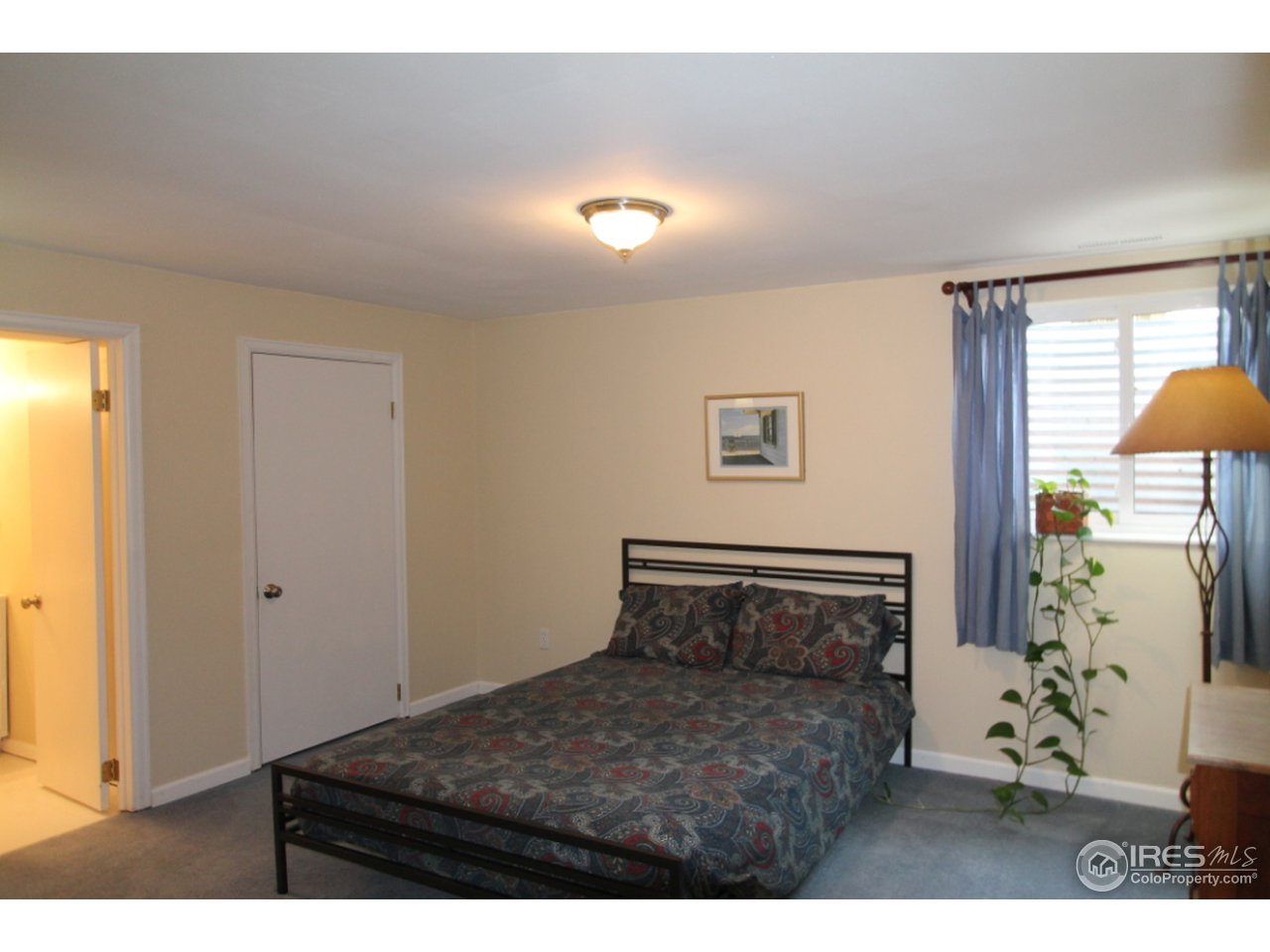 411 High Court Fort Collins, CO 80521 - Photo 18 of 25 a bedroom with a bed and a table
