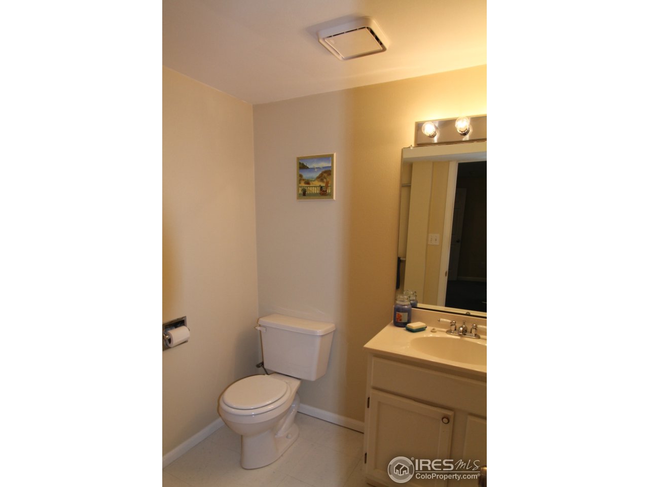 411 High Court Fort Collins, CO 80521 - Photo 19 of 25 a bathroom with a toilet sink and mirror