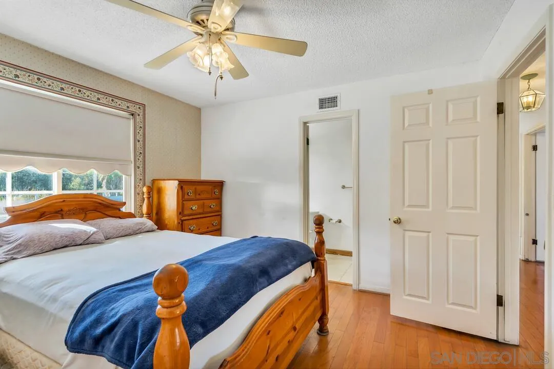 9326 Oakbourne Road Santee, CA 92071 - Photo 18 of 41 a bedroom with a bed and a chandelier