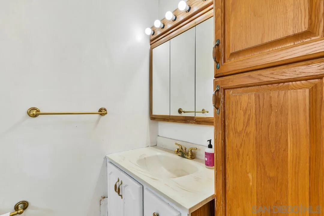 9326 Oakbourne Road Santee, CA 92071 - Photo 20 of 41 a bathroom with a sink and a mirror