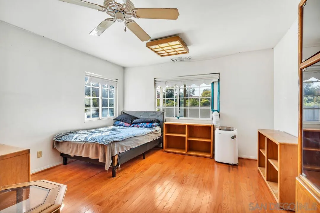 9326 Oakbourne Road Santee, CA 92071 - Photo 22 of 41 a bedroom with a bed and a table