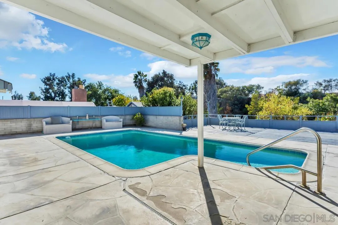 9326 Oakbourne Road Santee, CA 92071 - Photo 24 of 41 a view of a patio with a table and chairs under an umbrella