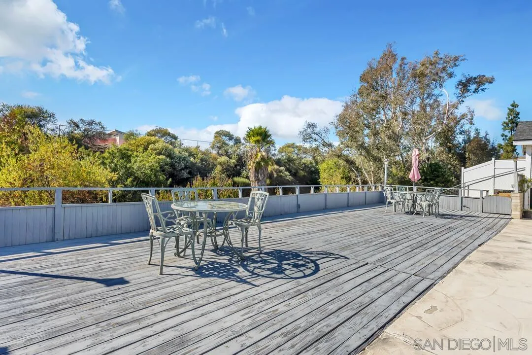 9326 Oakbourne Road Santee, CA 92071 - Photo 28 of 41 a view of a patio with table and chairs with wooden floor and fence