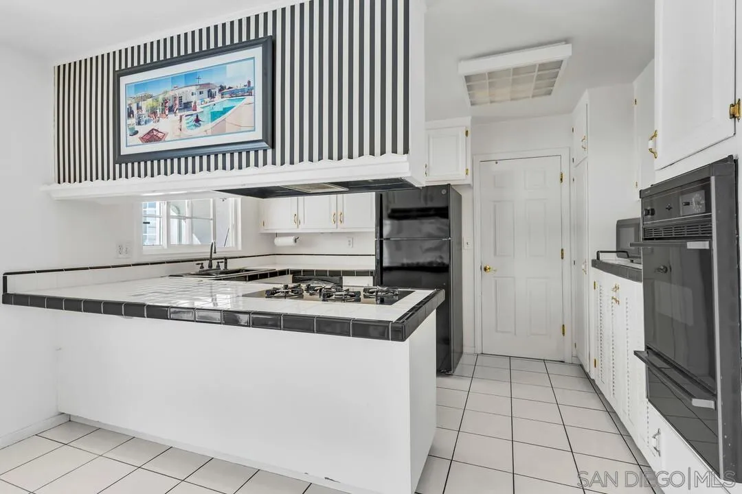 9326 Oakbourne Road Santee, CA 92071 - Photo 6 of 41 a kitchen with a stove a refrigerator and a sink