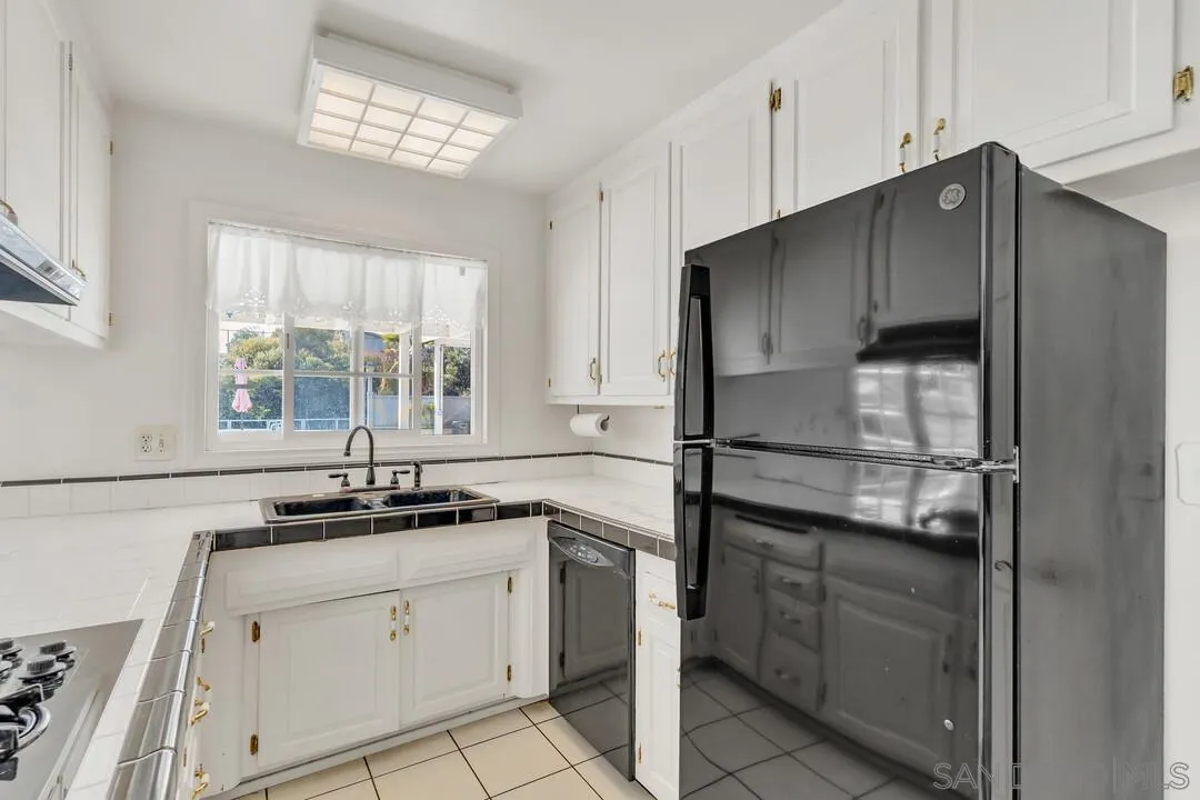 9326 Oakbourne Road Santee, CA 92071 - Photo 9 of 41 a kitchen with a sink and cabinets