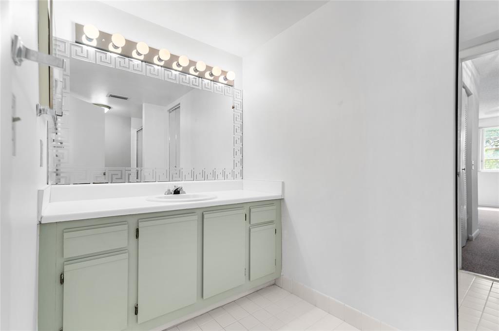 9676 West McNab Road, Unit 110 Fort Lauderdale, FL 33321 - Photo 15 of 26 a bathroom with a double vanity sink and a mirror