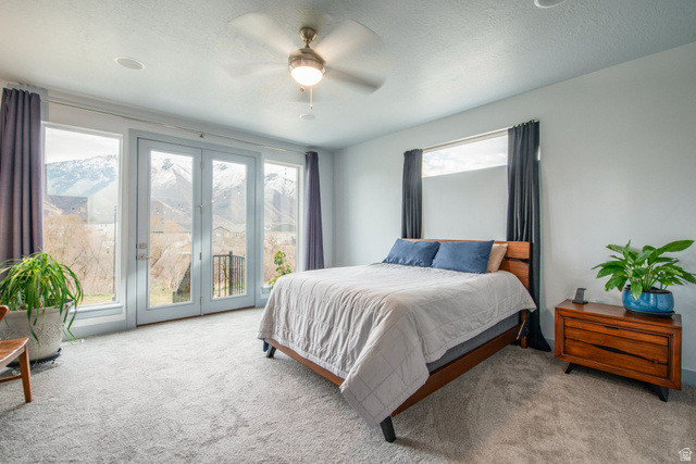 262 North Santa Fe Drive Mapleton, UT 84664 - Photo 16 of 28 Carpeted bedroom featuring access to exterior, ceiling fan, and a textured ceiling