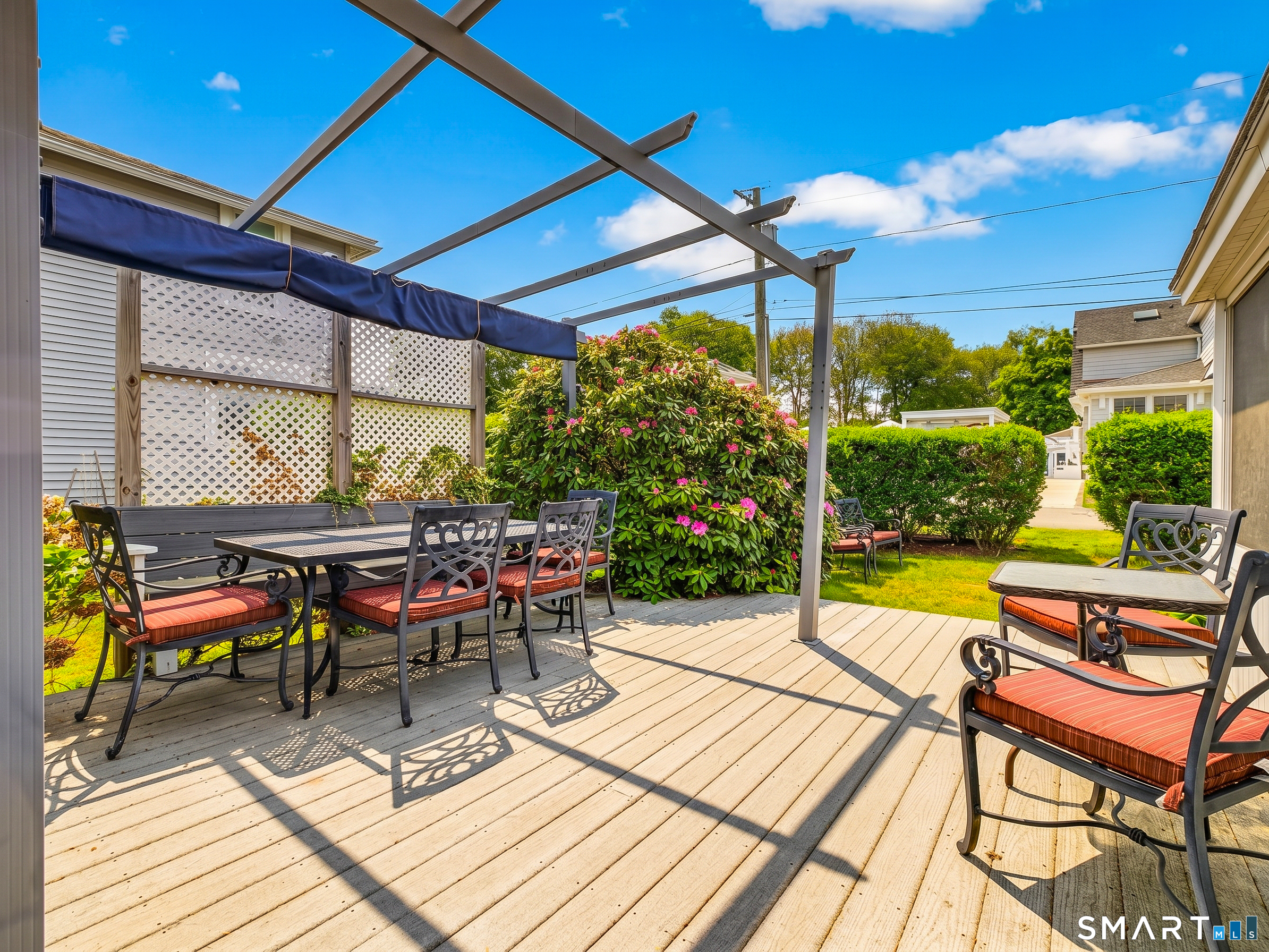 31 Old Colony Road Old Lyme, CT 06371 - Photo 13 of 38 a view of a patio with a dining table and chairs under an umbrella with a patio