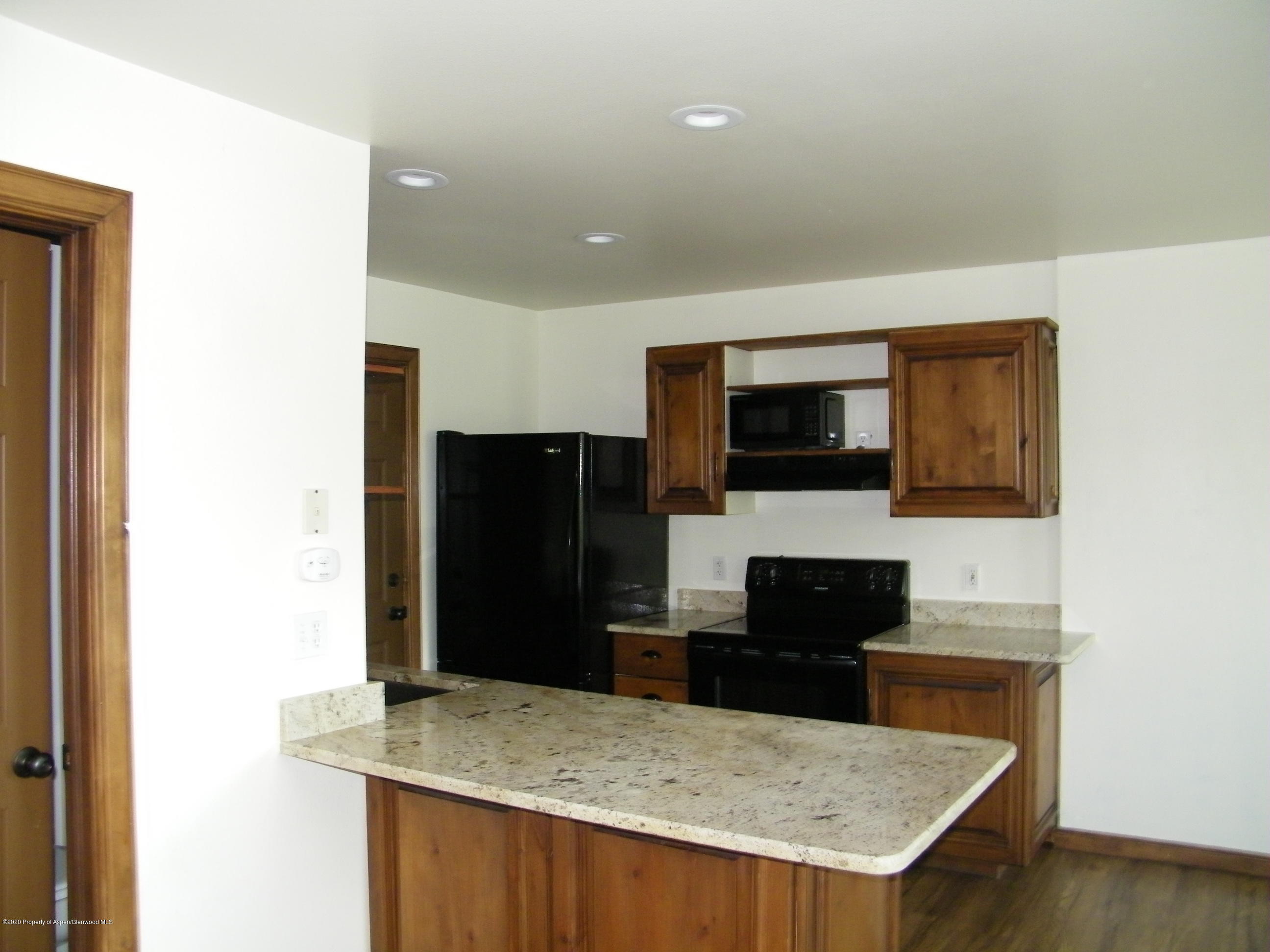 678 Alder Ridge Lane New Castle, CO 81647 - Photo 2 of 18 a kitchen with a cabinet a microwave and refrigerator