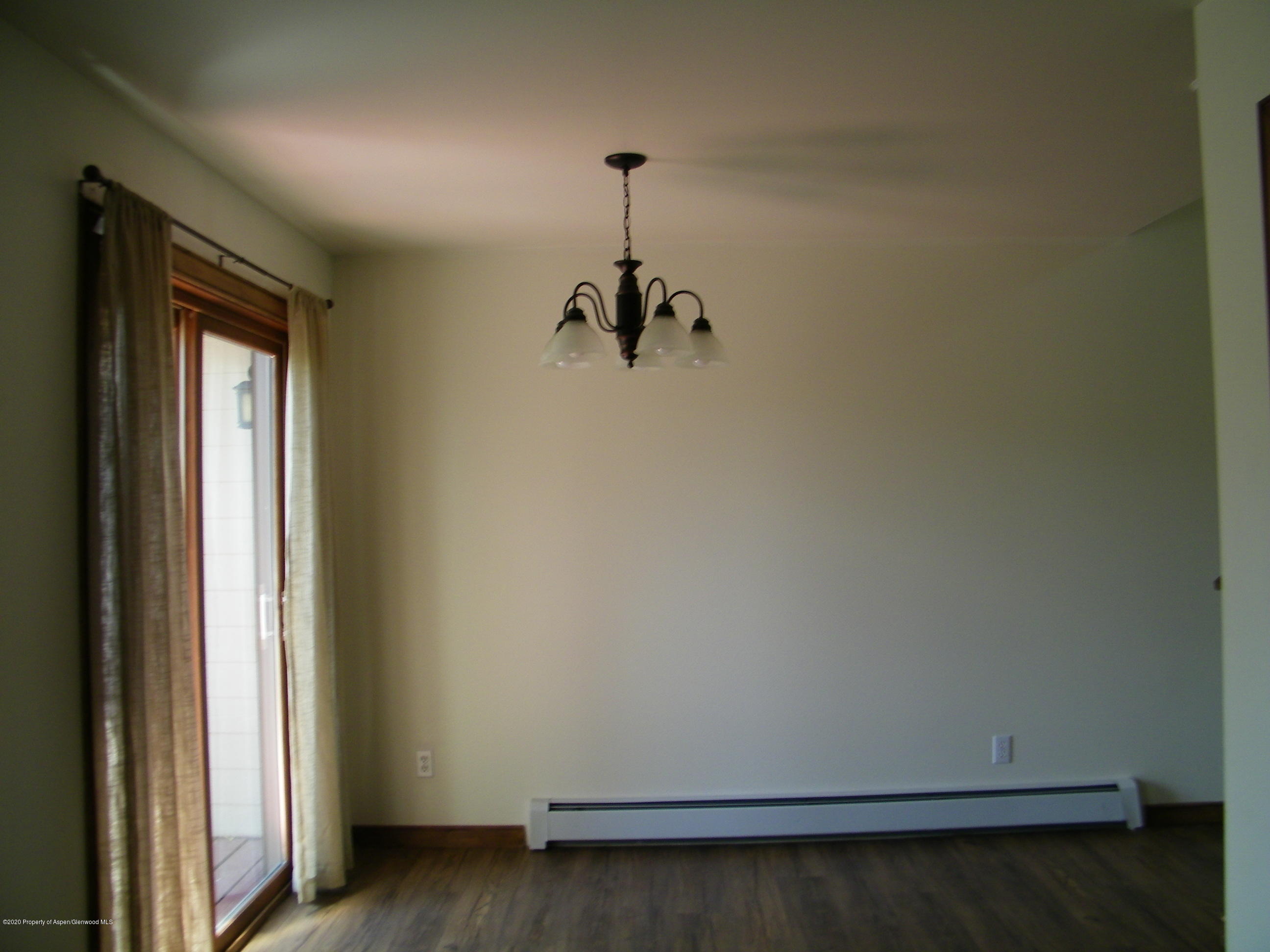 678 Alder Ridge Lane New Castle, CO 81647 - Photo 5 of 18 a view of a room with wooden floor and a window