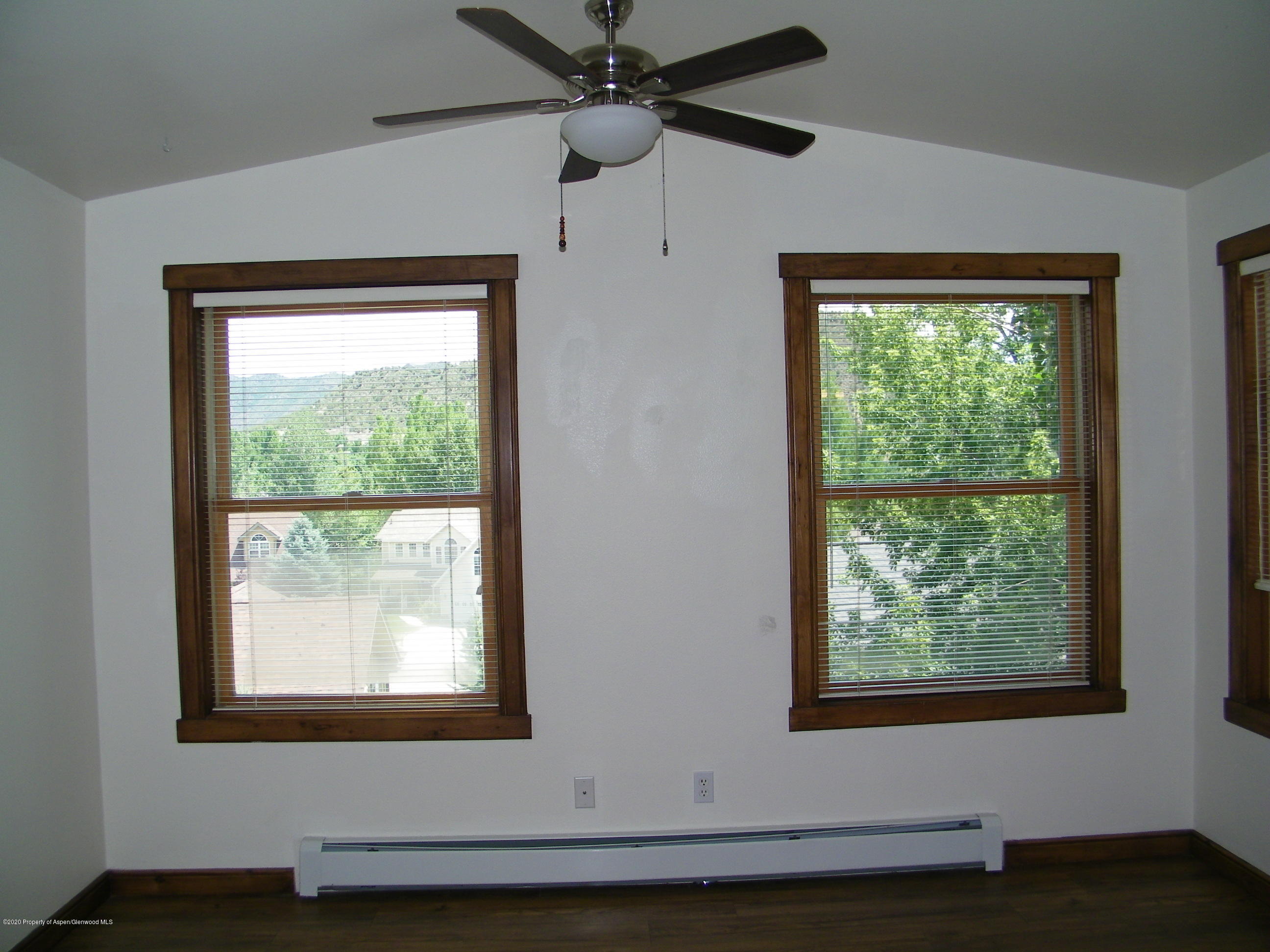 678 Alder Ridge Lane New Castle, CO 81647 - Photo 7 of 18 a view of an empty room with wooden floor and a window