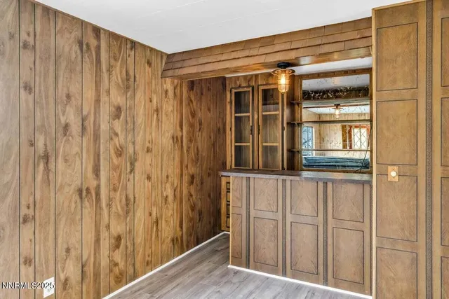 a large kitchen with a wooden floor and large windows