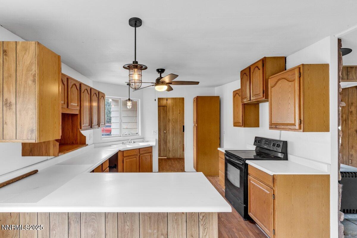 1211 Slate Road Topaz Ranch Estates, NV 89444 - Photo 19 of 30 a kitchen with stainless steel appliances granite countertop a sink dishwasher and a refrigerator with wooden floor
