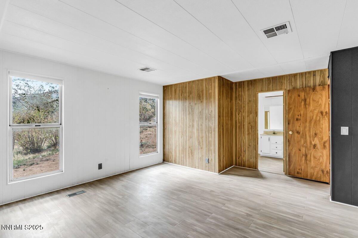 1211 Slate Road Topaz Ranch Estates, NV 89444 - Photo 21 of 30 a view of an empty room with wooden floor and a window