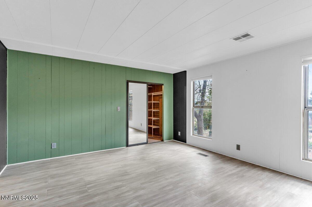 1211 Slate Road Topaz Ranch Estates, NV 89444 - Photo 22 of 30 a view of an empty room with wooden floor and closet