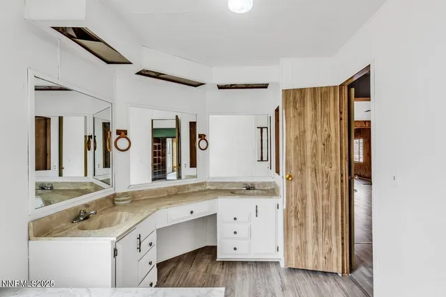 a bathroom with a tub a sink and a window