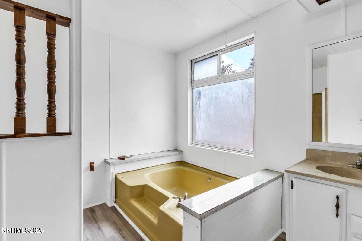 1211 Slate Road Topaz Ranch Estates, NV 89444 - Photo 24 of 30 a bathroom with a tub a sink and a window