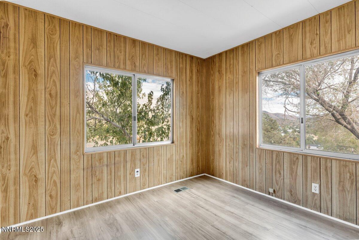 1211 Slate Road Topaz Ranch Estates, NV 89444 - Photo 27 of 30 a view of an empty room with wooden floor and a window