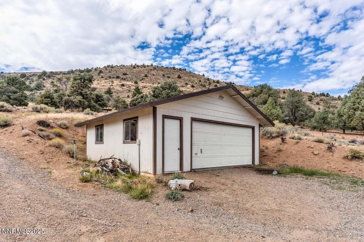 1211 Slate Road Topaz Ranch Estates, NV 89444 - Photo 5 of 30 a house with trees in the background