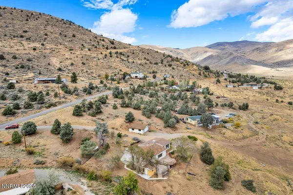 a view of a dry yard with mountains in the background