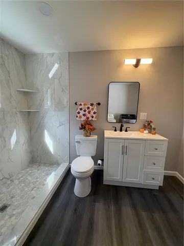 a bathroom with a toilet a sink and a mirror