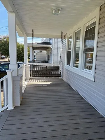 a view of deck with furniture and floor to ceiling window