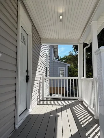 a view of a balcony with wooden floor