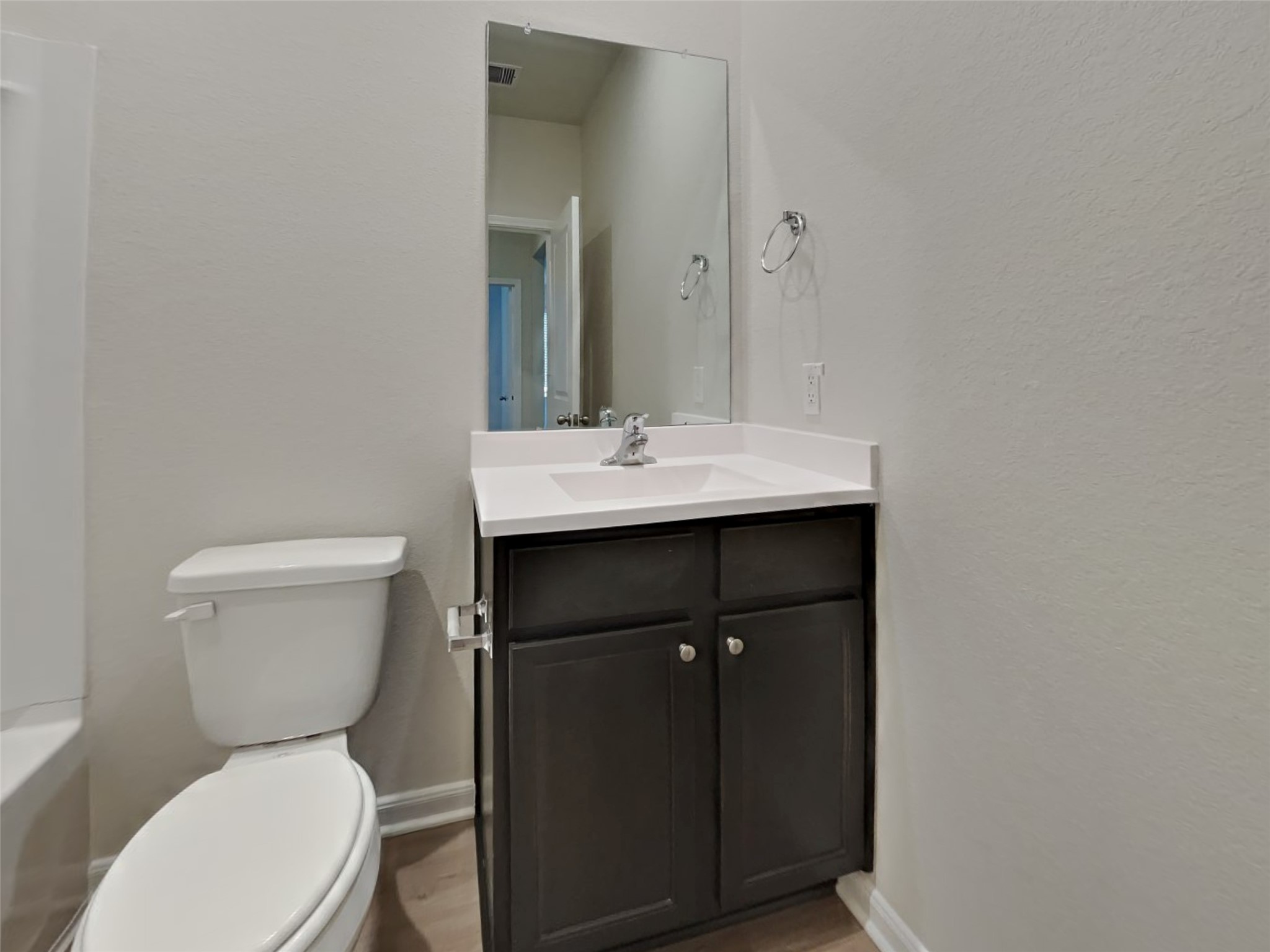15419 Maple Ter Drive Conroe, TX 77303 - Photo 12 of 26 a bathroom with a toilet a sink and mirror