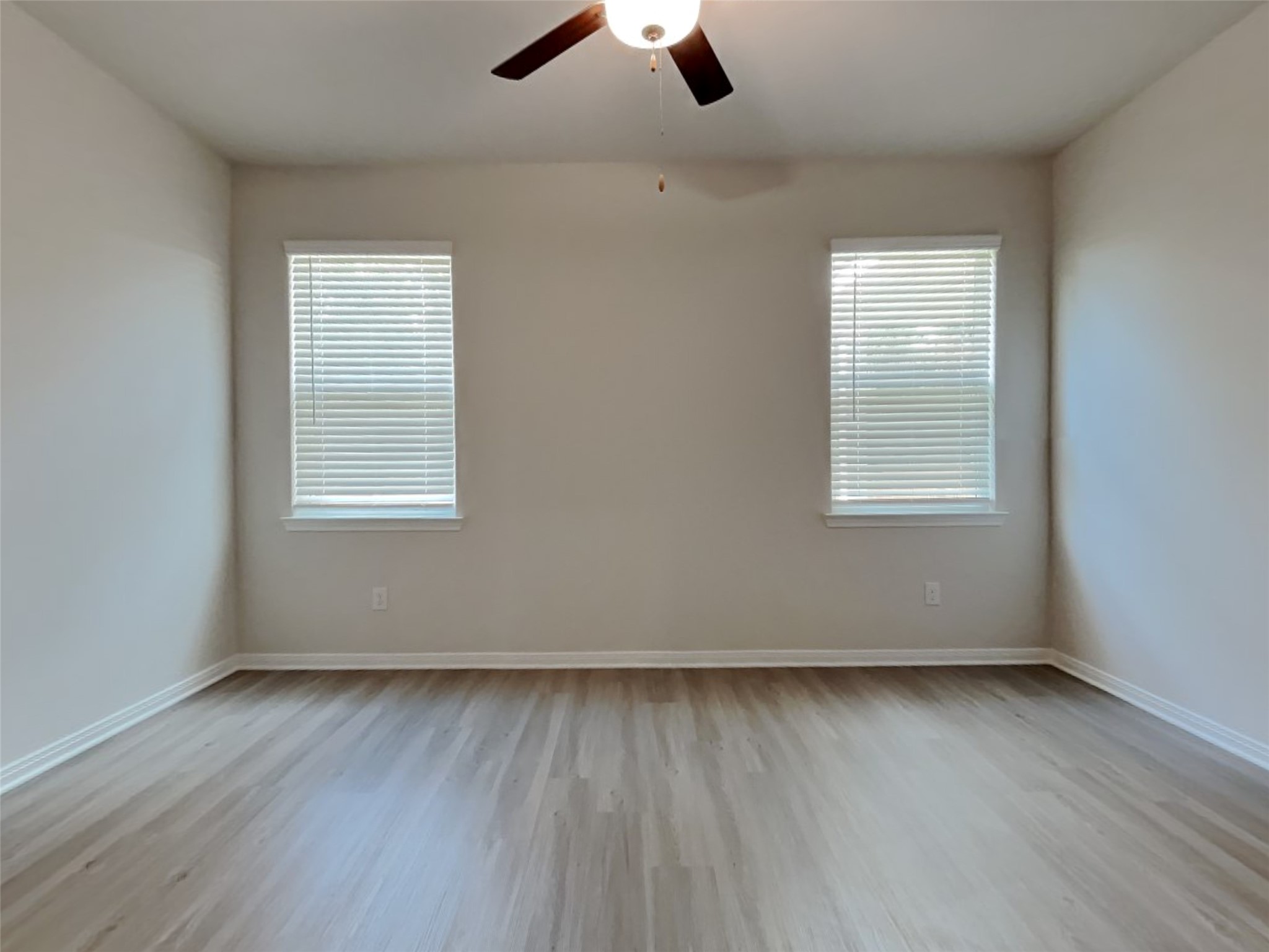 15419 Maple Ter Drive Conroe, TX 77303 - Photo 19 of 26 an empty room with wooden floor cabinet and windows
