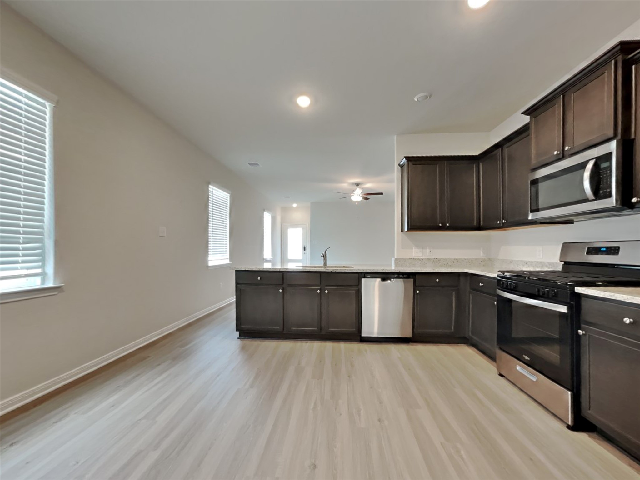 15419 Maple Ter Drive Conroe, TX 77303 - Photo 21 of 26 a kitchen with stainless steel appliances granite countertop a stove a sink and a refrigerator