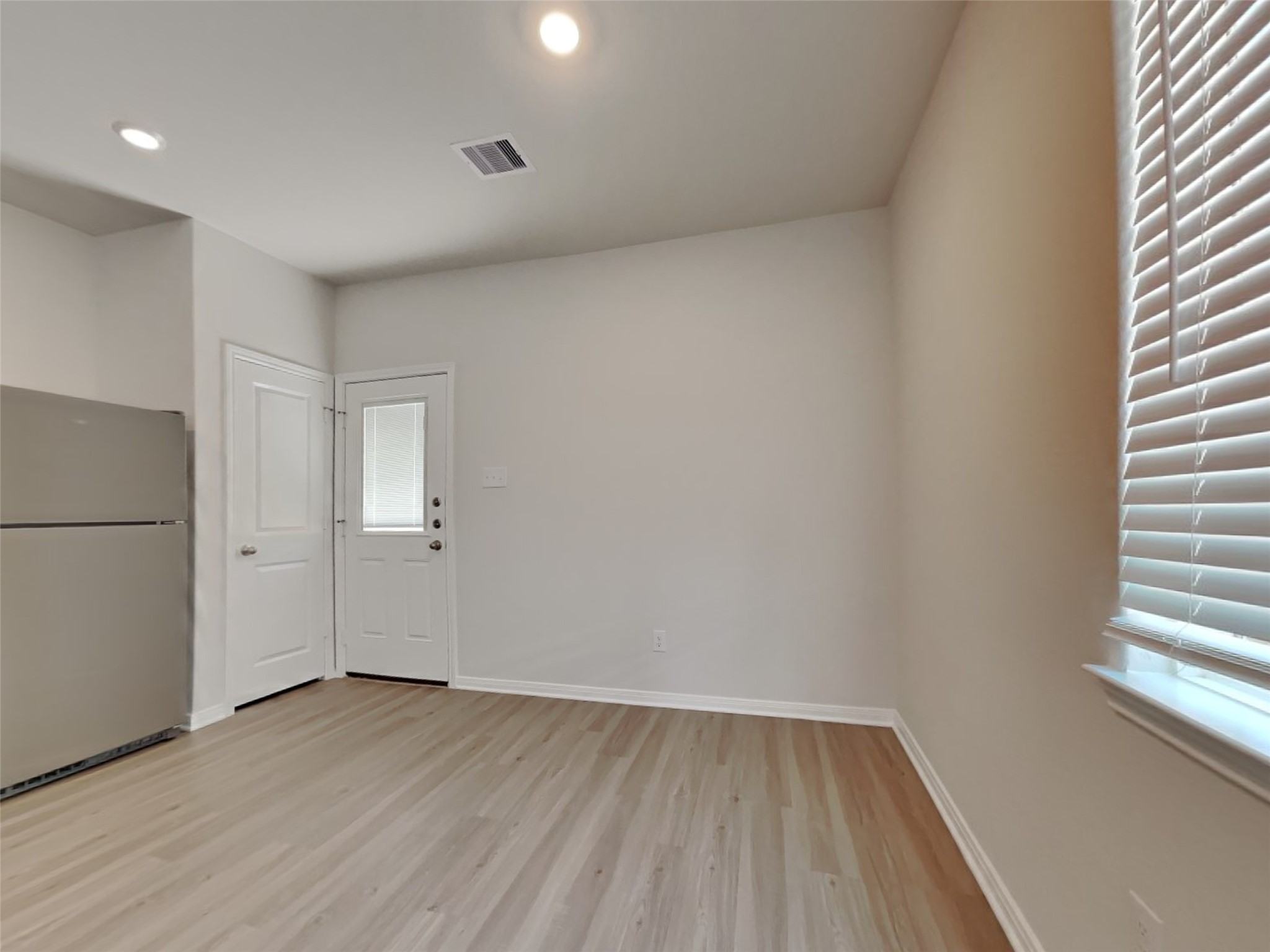 15419 Maple Ter Drive Conroe, TX 77303 - Photo 23 of 26 a view of a room with wooden floor and window