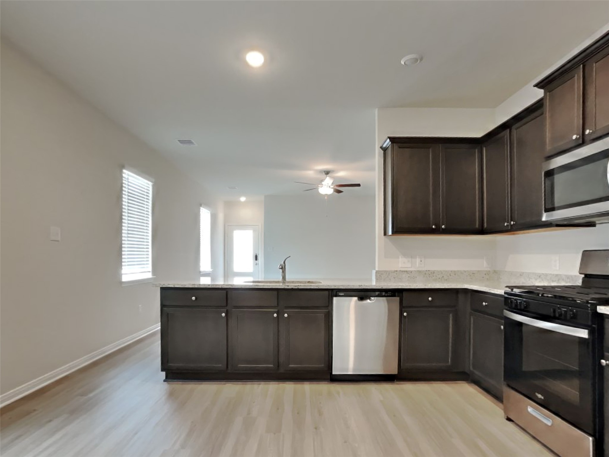15419 Maple Ter Drive Conroe, TX 77303 - Photo 5 of 26 a kitchen with a sink cabinets and window