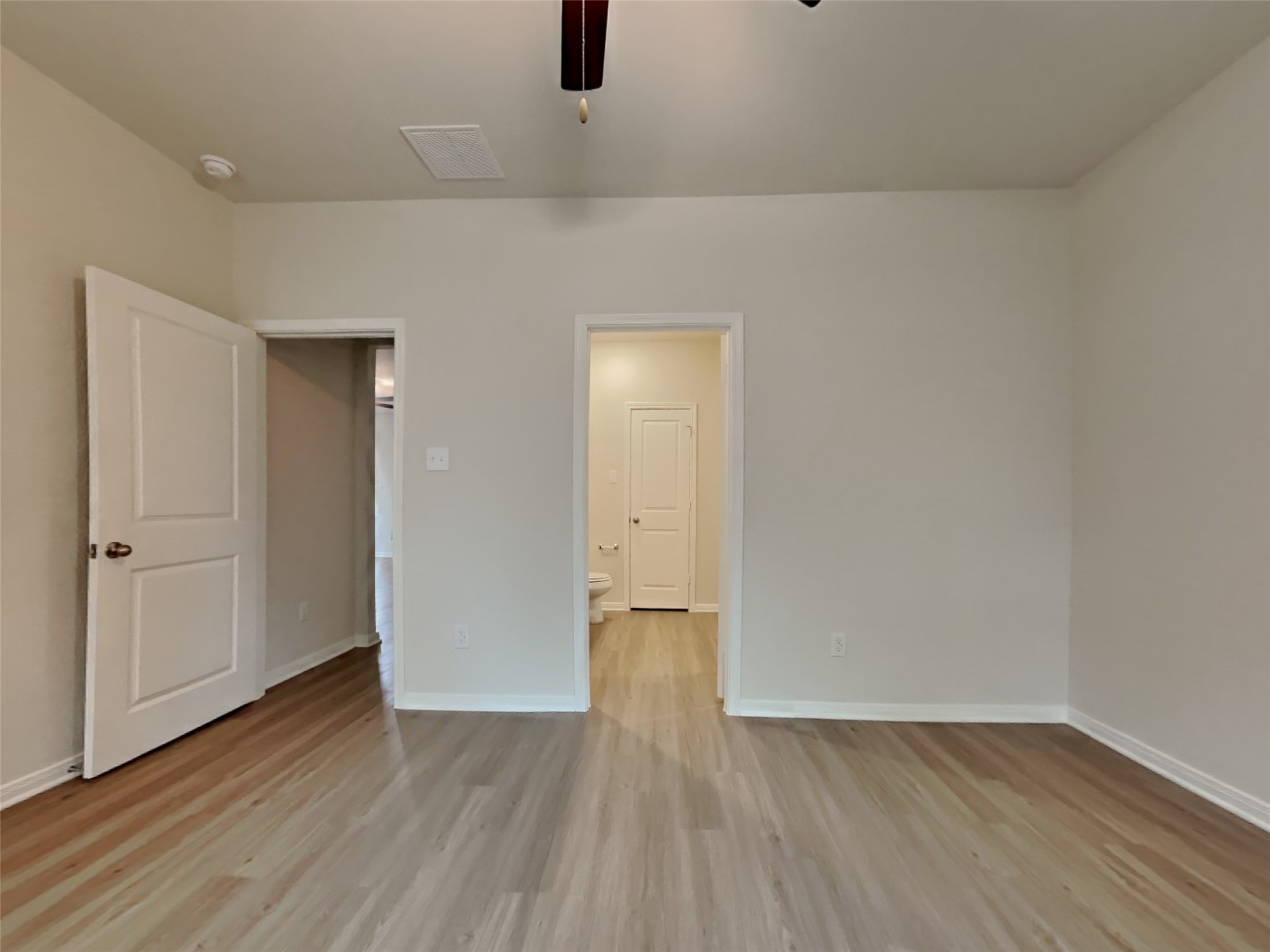 15419 Maple Ter Drive Conroe, TX 77303 - Photo 7 of 26 a view of an empty room with wooden floor and a window