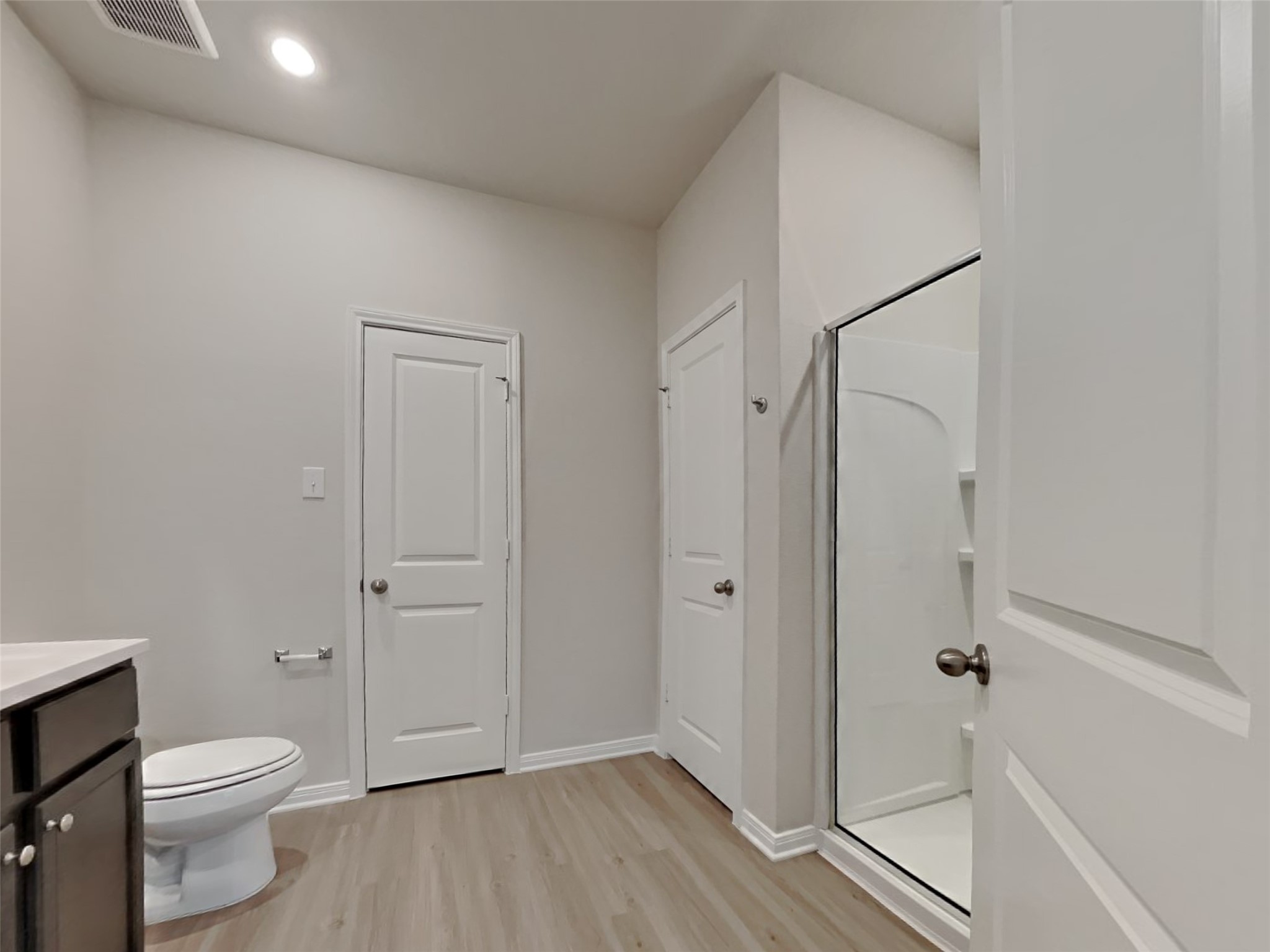 15419 Maple Ter Drive Conroe, TX 77303 - Photo 9 of 26 a bathroom with a granite countertop toilet a sink and shower