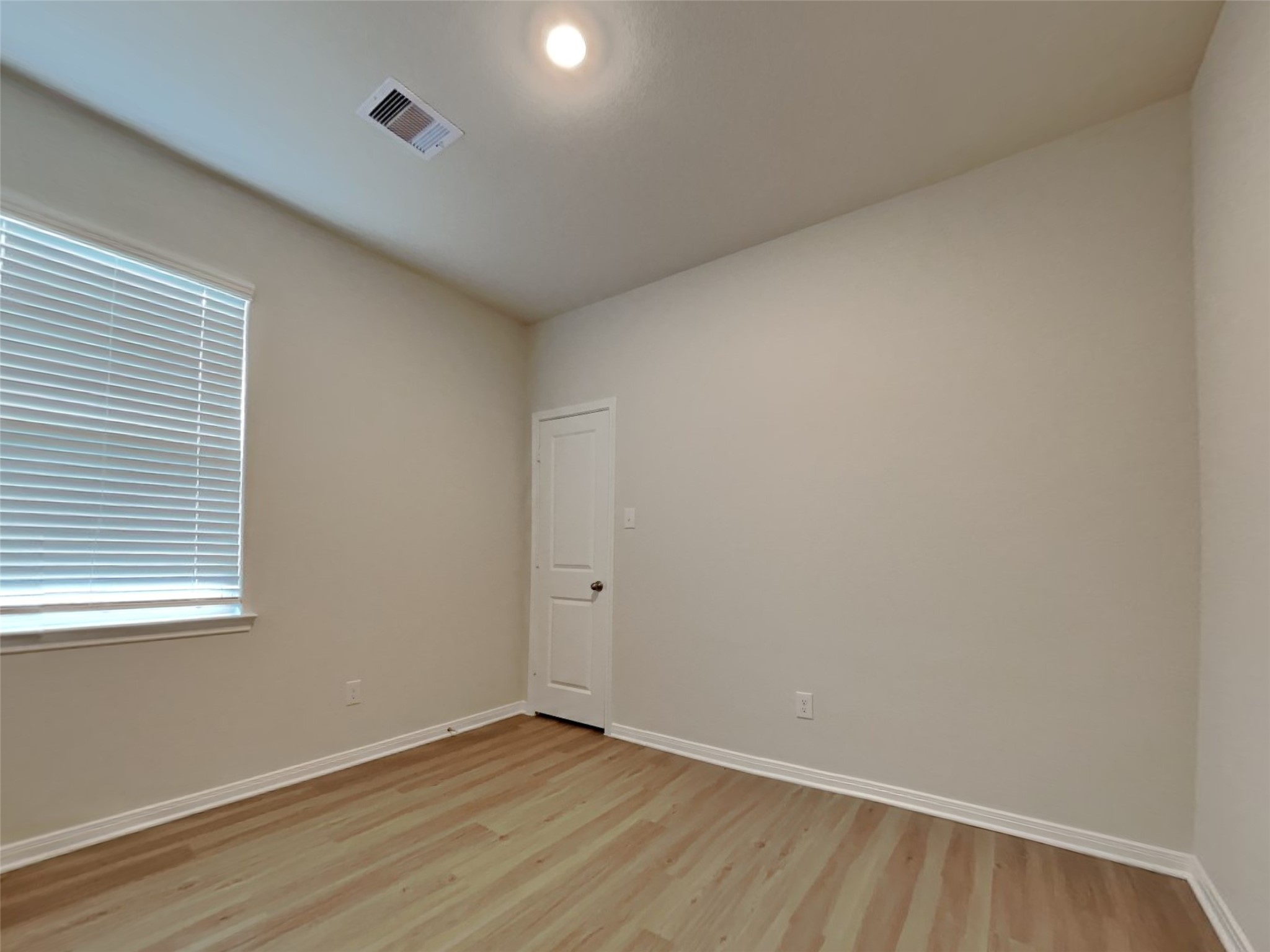 15419 Maple Ter Drive Conroe, TX 77303 - Photo 10 of 26 a view of an empty room with wooden floor and a window