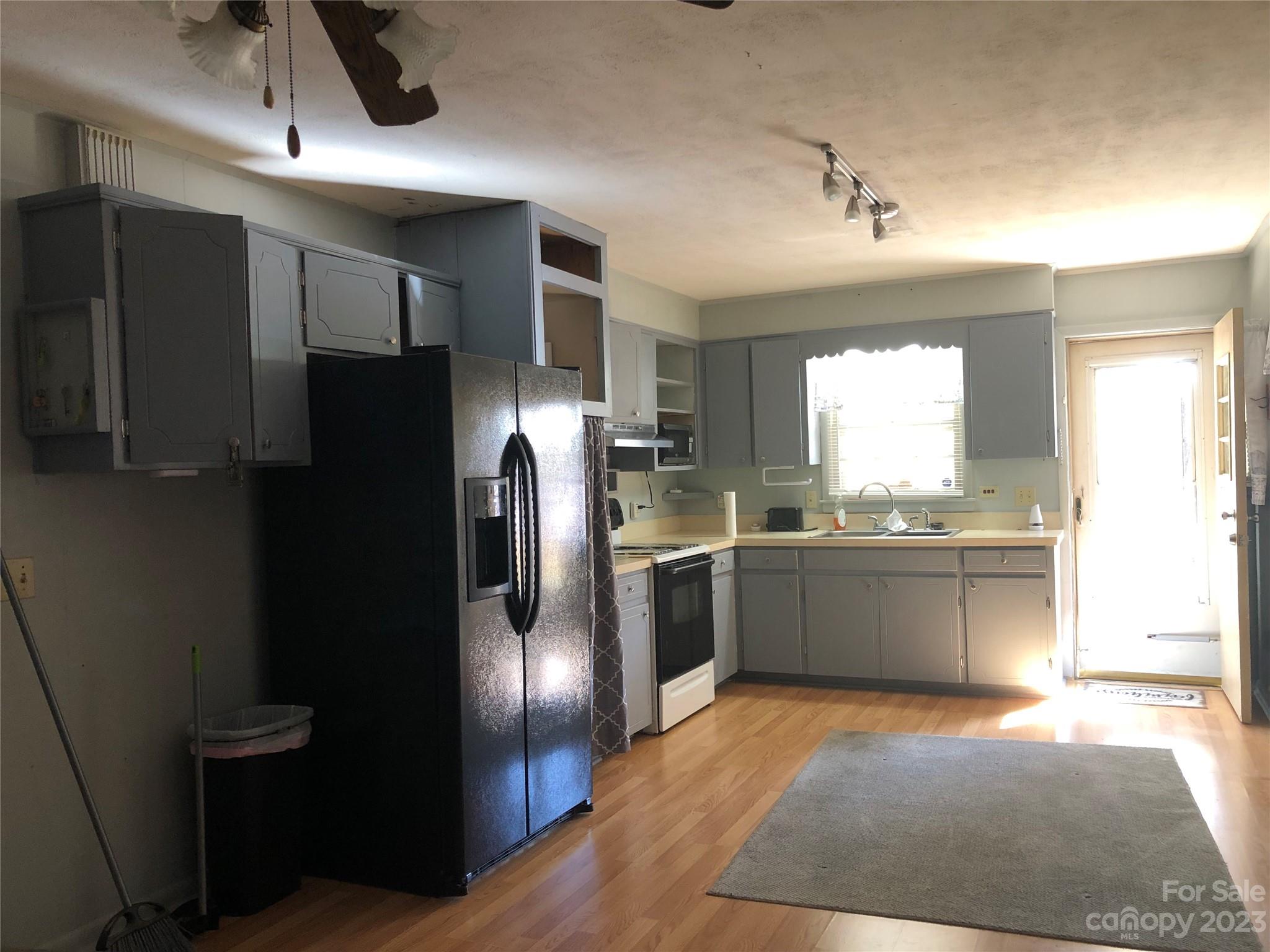 530 Shelton Road Clyde, NC 28721 - Photo 14 of 36 a kitchen with stainless steel appliances granite countertop a refrigerator a sink and dishwasher
